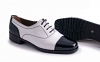 Charlí model shoe, made in black and white patent leather.